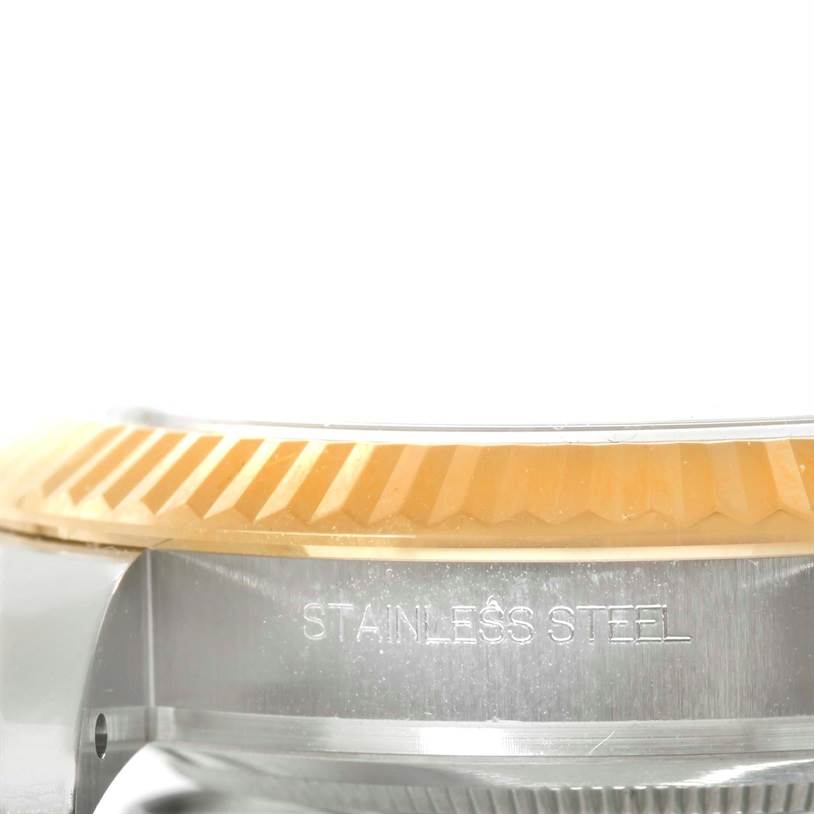 This close-up image of the Rolex Datejust 41 116333 Men
s Steel and Gold (two tone) Black Dial 116333 Men
s Steel and Gold (two tone) Black Dial watch shows its stainless steel case and part of the fluted bezel.