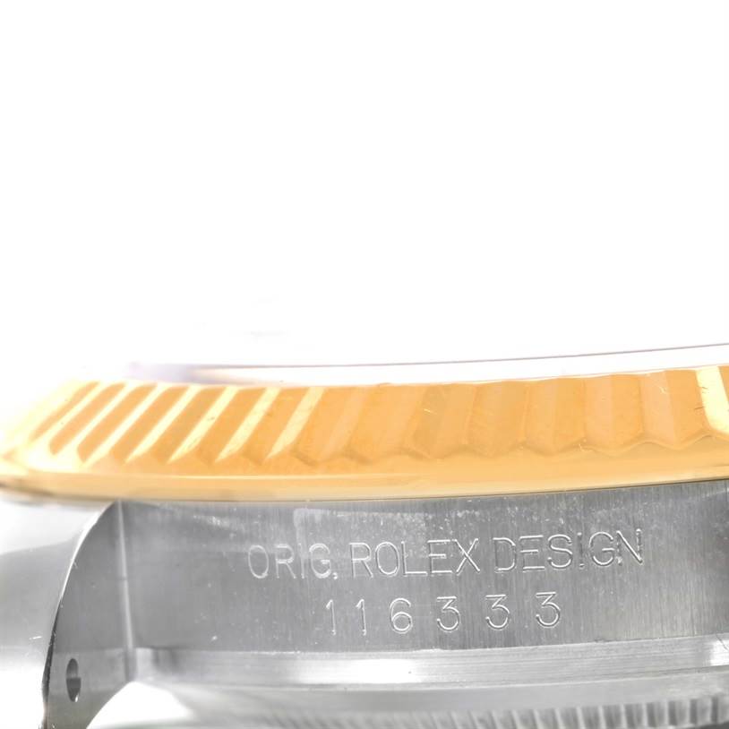 This image shows a close-up angle of the case side and fluted bezel of a Rolex Datejust 41 116333GYRO Men's Steel and Gold (two tone) Grey Dial 116333GYRO Men's Steel and Gold (two tone) Grey Dial watch.