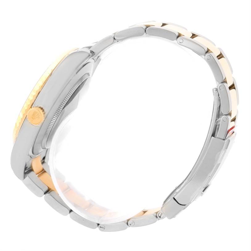 The side view of the Rolex Datejust 41 116333ISO Men's Steel and Gold (two tone) Beige Dial 116333ISO Men's Steel and Gold (two tone) Beige Dial watch showcases its case, crown, and two-tone metal bracelet.