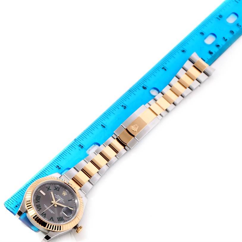 The image shows a Rolex Datejust 41 116333GYRO Men's Steel and Gold (two tone) Grey Dial 116333GYRO Men's Steel and Gold (two tone) Grey Dial watch laying flat, displaying its face, bezel, and bracelet next to a blue ruler.