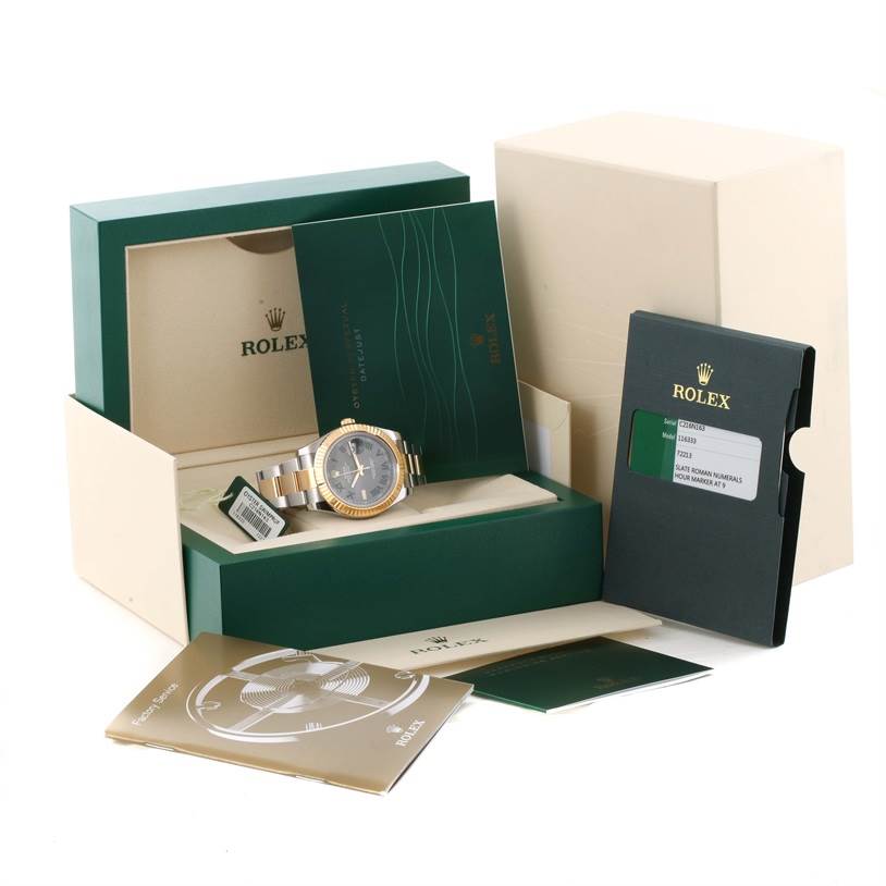 The image shows a Rolex Datejust 41 116333GYRO Men's Steel and Gold (two tone) Grey Dial 116333GYRO Men's Steel and Gold (two tone) Grey Dial watch with its packaging, manuals, warranty card, and other accessories from a front angle.