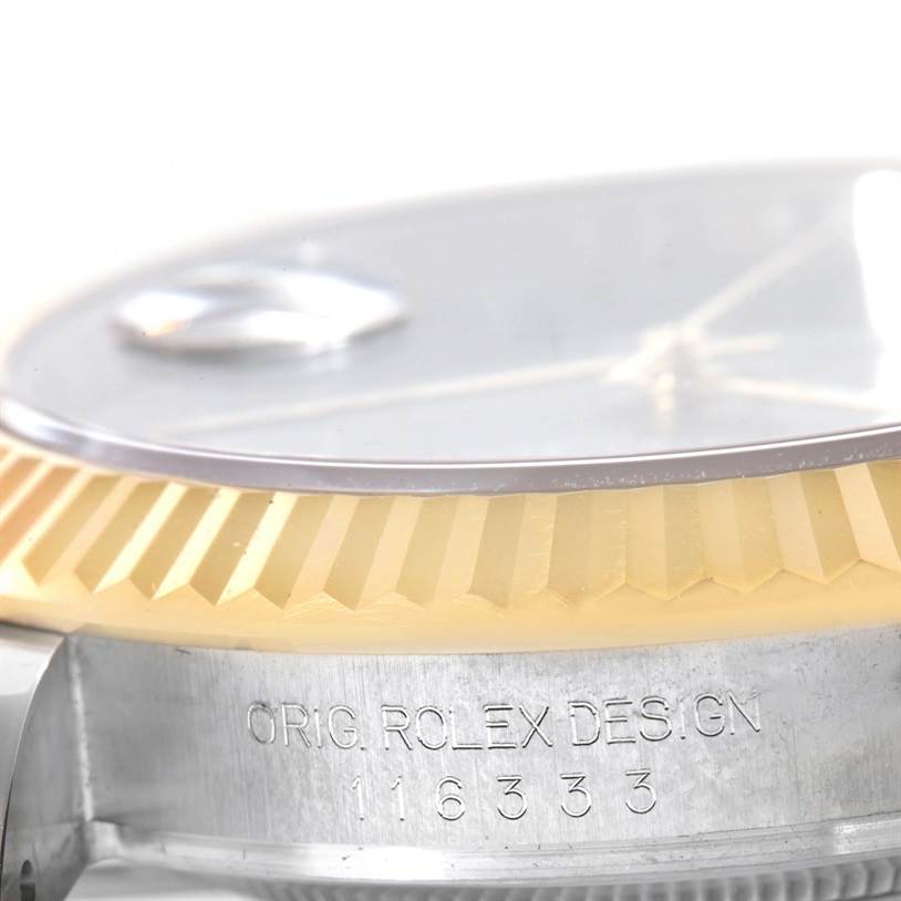 This image shows a close-up side view of the fluted bezel and case with the "ORIG. ROLEX DESIGN" engraving on the Rolex Datejust 41 116333GYRO Men's Steel and Gold (two tone) Grey Dial 116333GYRO Men's Steel and Gold (two tone) Grey Dial model.