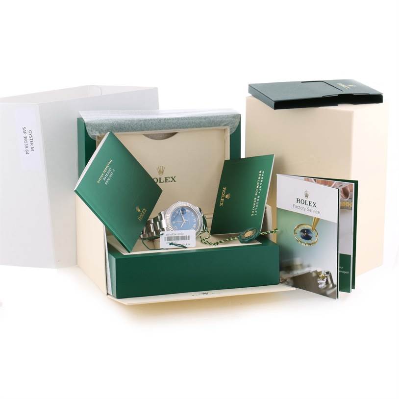 The image shows the Rolex Datejust 41 116334BLRO Men's Stainless Steel Blue Dial 116334BLRO Men's Stainless Steel Blue Dial watch and its accessories inside an open box with booklets and tags displayed.