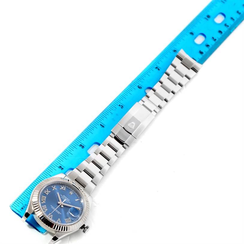 The Rolex Datejust 41 116334BLRO Men's Stainless Steel Blue Dial 116334BLRO Men's Stainless Steel Blue Dial watch is shown flat, with the face, strap, and clasp all visible alongside a ruler for scale.