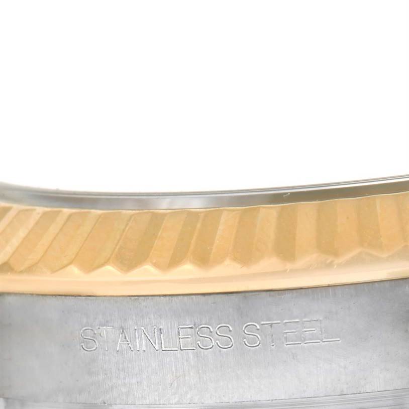 This close-up shows the fluted bezel and part of the stainless steel case of a Rolex Datejust 41 116333 Men's Steel and Gold (two tone) Grey Dial 116333 Men's Steel and Gold (two tone) Grey Dial model.