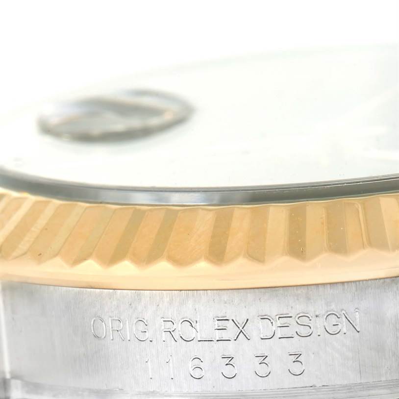 This close-up image shows the fluted bezel and engraving on the side of the Rolex Datejust 41 116333 Men's Steel and Gold (two tone) Grey Dial 116333 Men's Steel and Gold (two tone) Grey Dial watch.