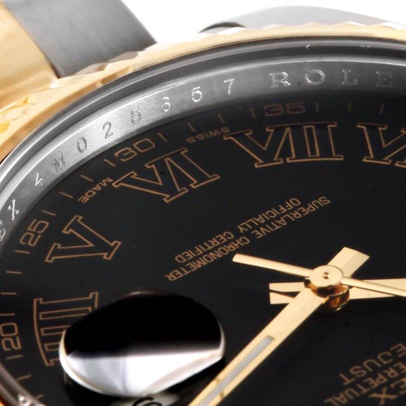 This close-up of the Rolex Datejust 41 116333 Men's Steel and Gold (two tone) Grey Dial 116333 Men's Steel and Gold (two tone) Grey Dial shows the dial, Roman numerals, cyclops lens, and part of the bezel with the serial number.