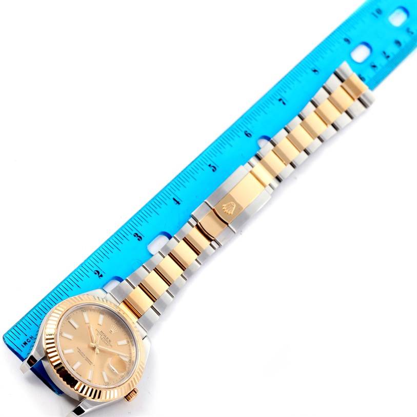 The image shows a Rolex Datejust 41 116333 Men's Steel and Gold (two tone) Champagne Dial 116333 Men's Steel and Gold (two tone) Champagne Dial watch laid horizontally alongside a blue ruler, displaying the face and bracelet.