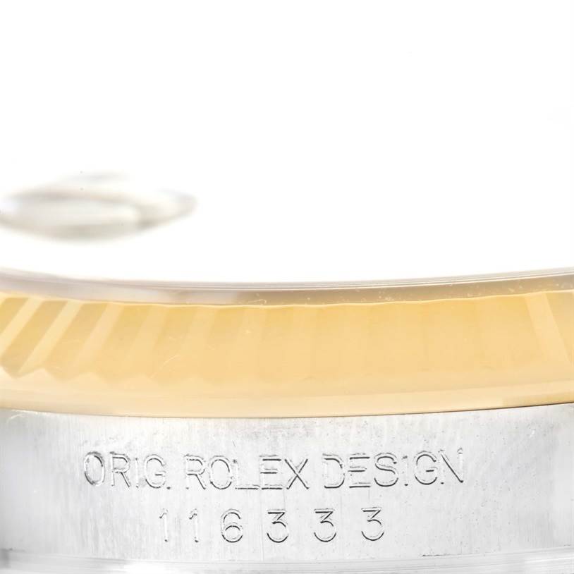 This image shows the etched serial number and part of the bezel on a Rolex Datejust 41 116333 Men's Steel and Gold (two tone) Champagne Dial 116333 Men's Steel and Gold (two tone) Champagne Dial.