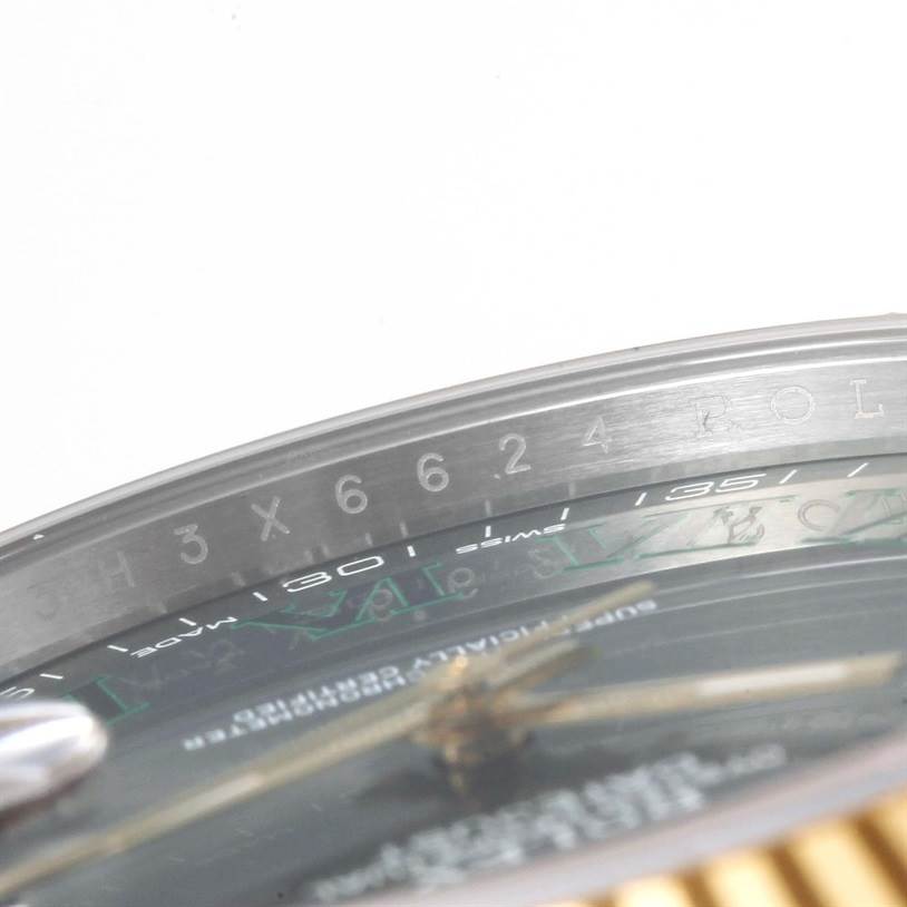 This close-up image of the Rolex Datejust 41 116333 Men's Steel and Gold (two tone) Grey Dial 116333 Men's Steel and Gold (two tone) Grey Dial shows the rehaut with serial numbers and part of the watch's dial and gold fluted bezel.