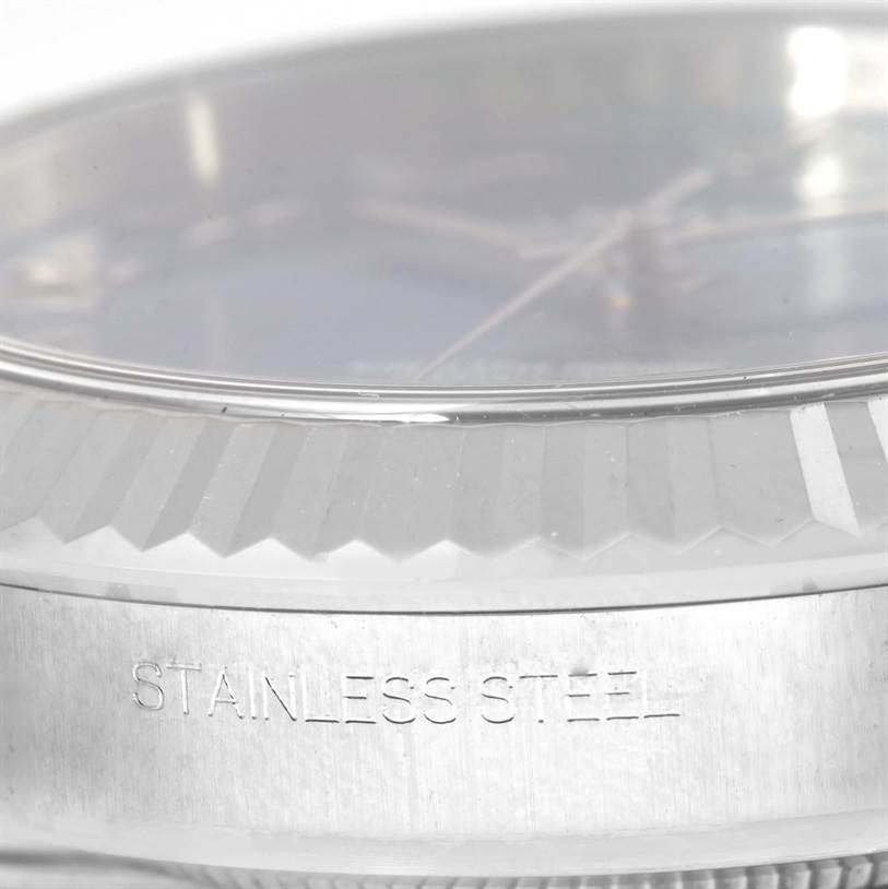 The image shows a close-up of the bezel and part of the case of a Rolex Datejust 41 116334BLRO Men's Stainless Steel Blue Dial 116334BLRO Men's Stainless Steel Blue Dial watch, highlighting the "Stainless Steel" engraving.