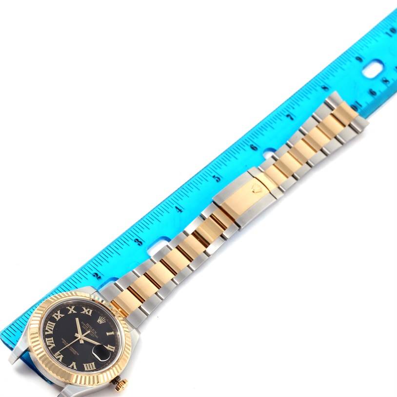 The image shows a Rolex Datejust 41 116333 Men's Steel and Gold (two tone) Black Dial 116333 Men's Steel and Gold (two tone) Black Dial watch laid flat beside a ruler, highlighting the watch's face and bracelet.