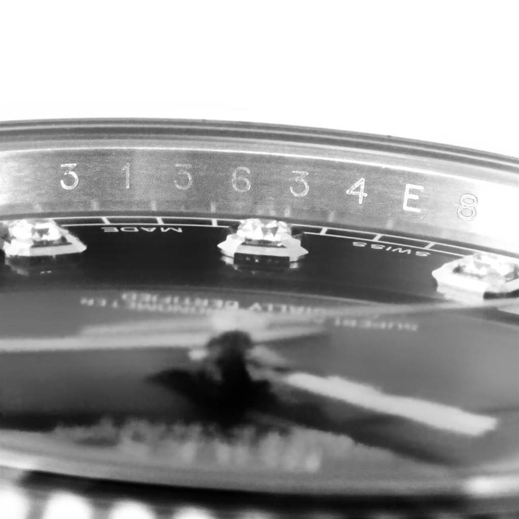 The image shows a close-up, angled view of the dial and chapter ring of a Rolex Datejust 41 116334BLRO Men's Stainless Steel Grey Dial 116334BLRO Men's Stainless Steel Grey Dial, focusing on the serial number.