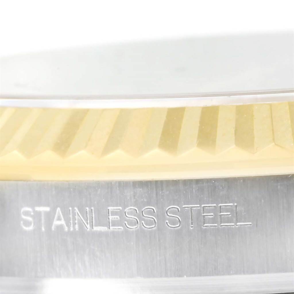 The image shows a close-up of the fluted bezel and case side of a Rolex Datejust 41 116333 Men's Steel and Gold (two tone) Black Dial 116333 Men's Steel and Gold (two tone) Black Dial, highlighting the "STAINLESS STEEL" engraving.