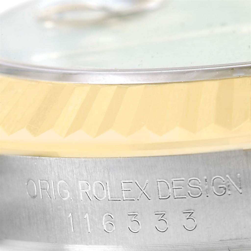 The image shows a close-up of the side of a Rolex Datejust 41 116333 Men's Steel and Gold (two tone) Black Dial 116333 Men's Steel and Gold (two tone) Black Dial watch, detailing the fluted bezel and the engraved casing with its model number.