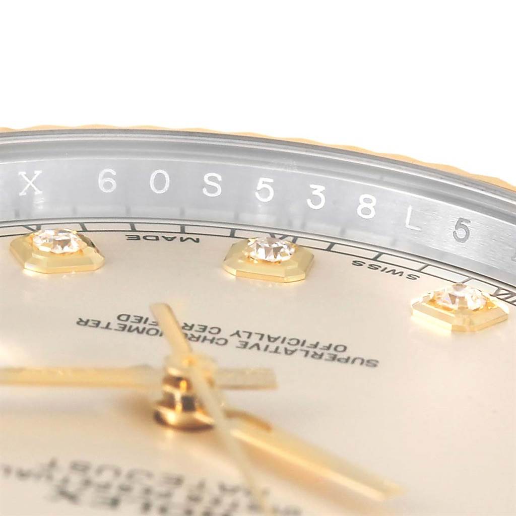 This close-up angle of the Rolex Datejust 41 116333 Men's Steel and Gold (two tone) Beige Dial 116333 Men's Steel and Gold (two tone) Beige Dial model shows part of the dial, diamond markers, and the serial number on the rehaut.