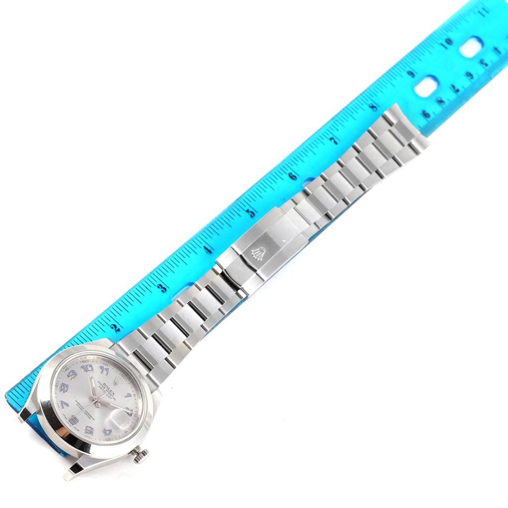 The image shows a top view of a Rolex Datejust 41 116300 Men's Stainless Steel Silver Dial 116300 Men's Stainless Steel Silver Dial, displaying the watch face and bracelet alongside a blue ruler.