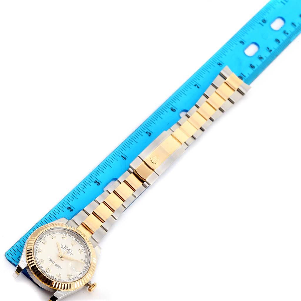 The Rolex Datejust 41 116333 Men's Steel and Gold (two tone) Beige Dial 116333 Men's Steel and Gold (two tone) Beige Dial watch is shown from a top-down angle with a focus on the face, dial, and bracelet next to a ruler.