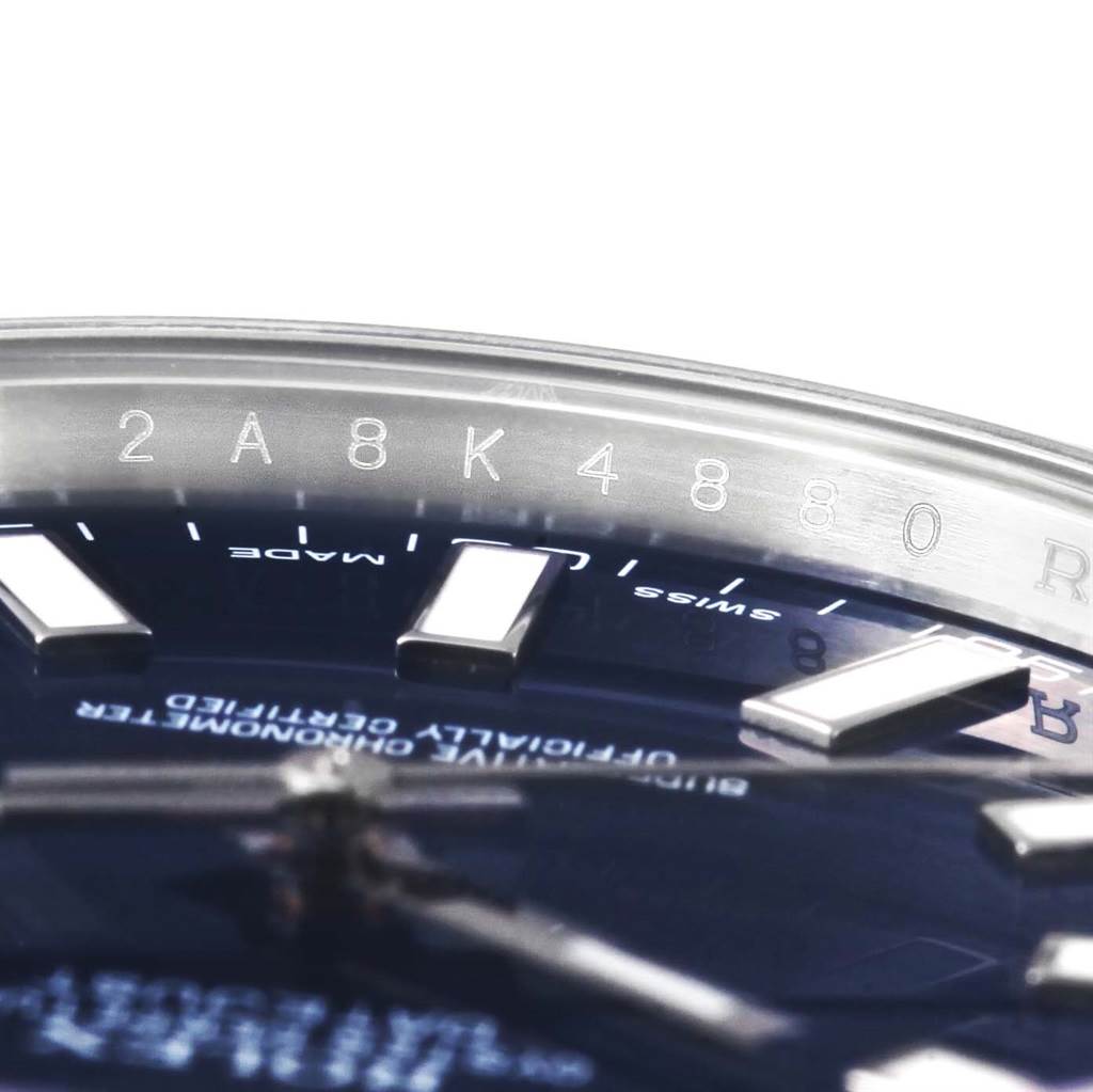 The image shows a close-up of the serial number and part of the dial of a Rolex Datejust 41 116300 Men's Stainless Steel Blue Dial 116300 Men's Stainless Steel Blue Dial watch.