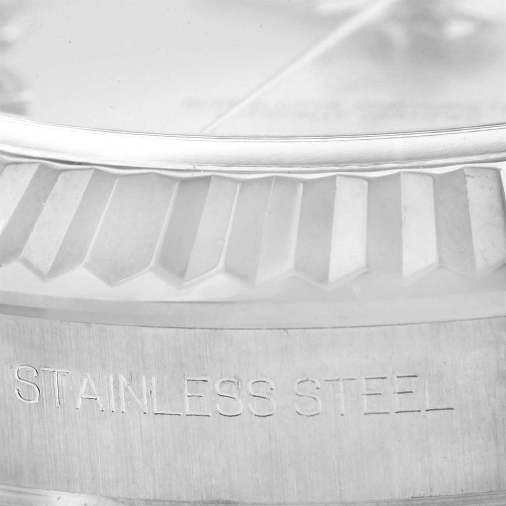 This image shows a close-up of the bezel and part of the stainless steel casing of a Rolex Datejust 41 116334 Men's Stainless Steel Grey Dial 116334 Men's Stainless Steel Grey Dial watch.