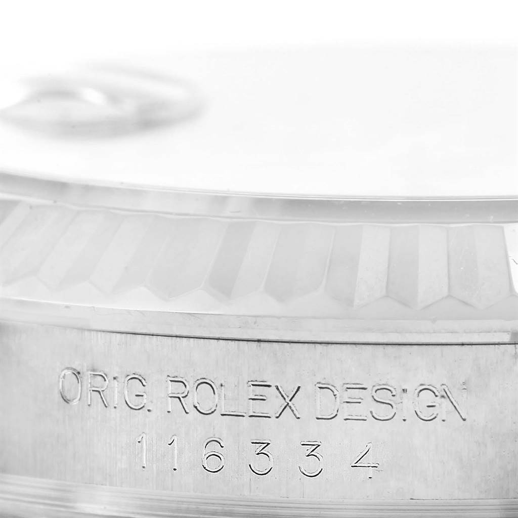 The image shows a close-up of the side of the Rolex Datejust 41 116334 Men's Stainless Steel Grey Dial 116334 Men's Stainless Steel Grey Dial model, focusing on the fluted bezel and engraved serial number.