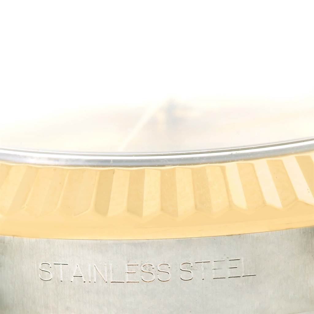 The image shows a close-up of the bezel and part of the case back of a Rolex Datejust 41 116333 Men's Steel and Gold (two tone) Champagne Dial 116333 Men's Steel and Gold (two tone) Champagne Dial model, highlighting its fluted design and "Stainless Steel" engraving.