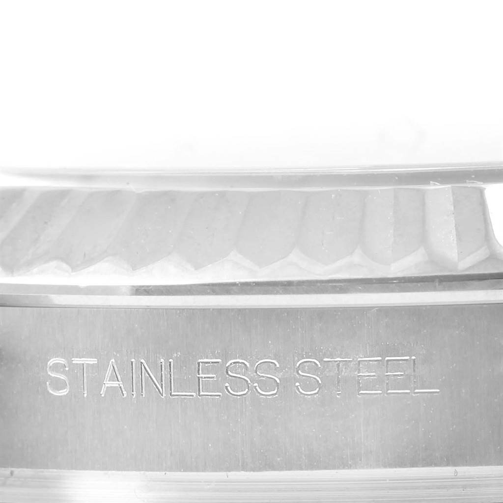 This close-up image shows the fluted bezel and the "STAINLESS STEEL" engraved part of the Rolex Datejust 41 116334 Men's Stainless Steel Black Dial 116334 Men's Stainless Steel Black Dial watch.