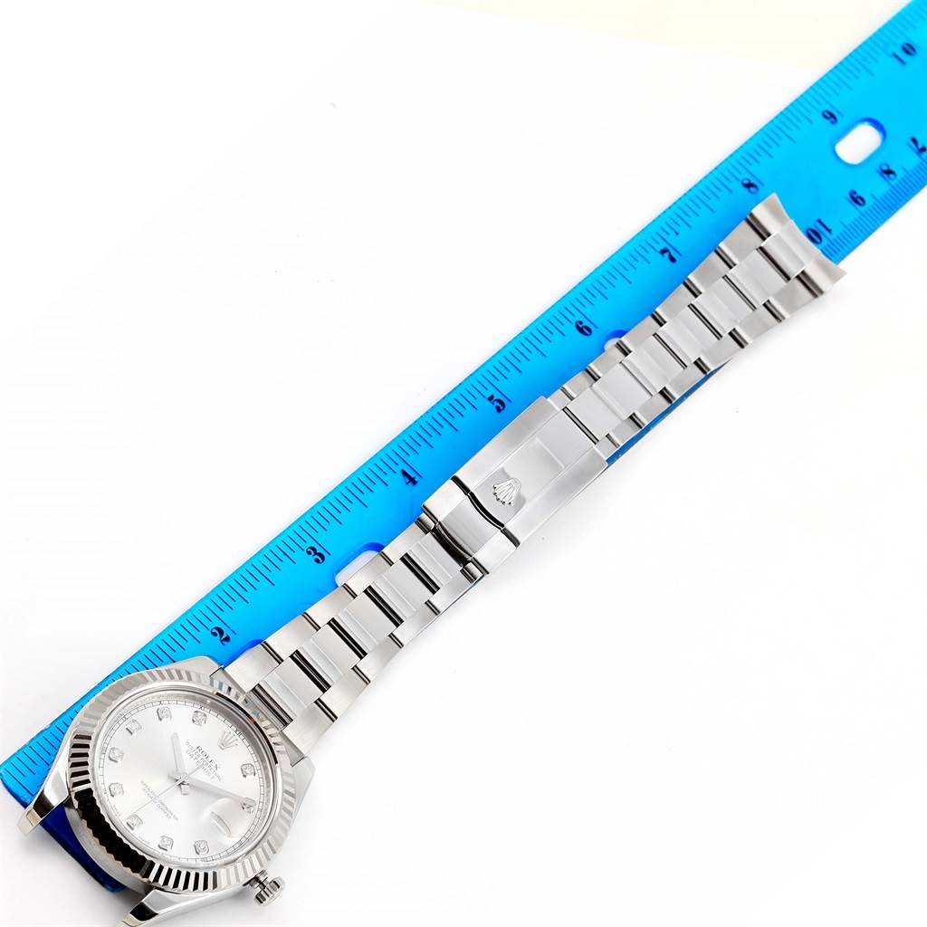 The image shows a top-down view of the Rolex Datejust 41 116334 Men's Stainless Steel Silver Dial 116334 Men's Stainless Steel Silver Dial watch, including the face, bezel, bracelet, and clasp, with a ruler for scale.