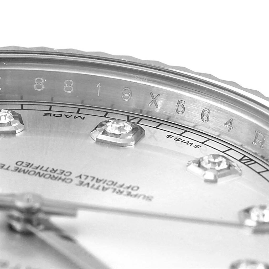 This close-up image of the Rolex Datejust 41 116334 Men's Stainless Steel Silver Dial 116334 Men's Stainless Steel Silver Dial watch shows part of the dial and engraved rehaut, highlighting the diamond hour markers and inscriptions.