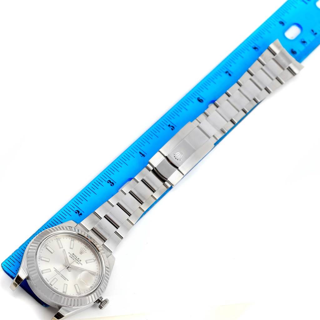 The image shows a Rolex Datejust 41 116334 Men's Stainless Steel Silver Dial 116334 Men's Stainless Steel Silver Dial watch laid flat next to a blue ruler, displaying the face, strap, and clasp.