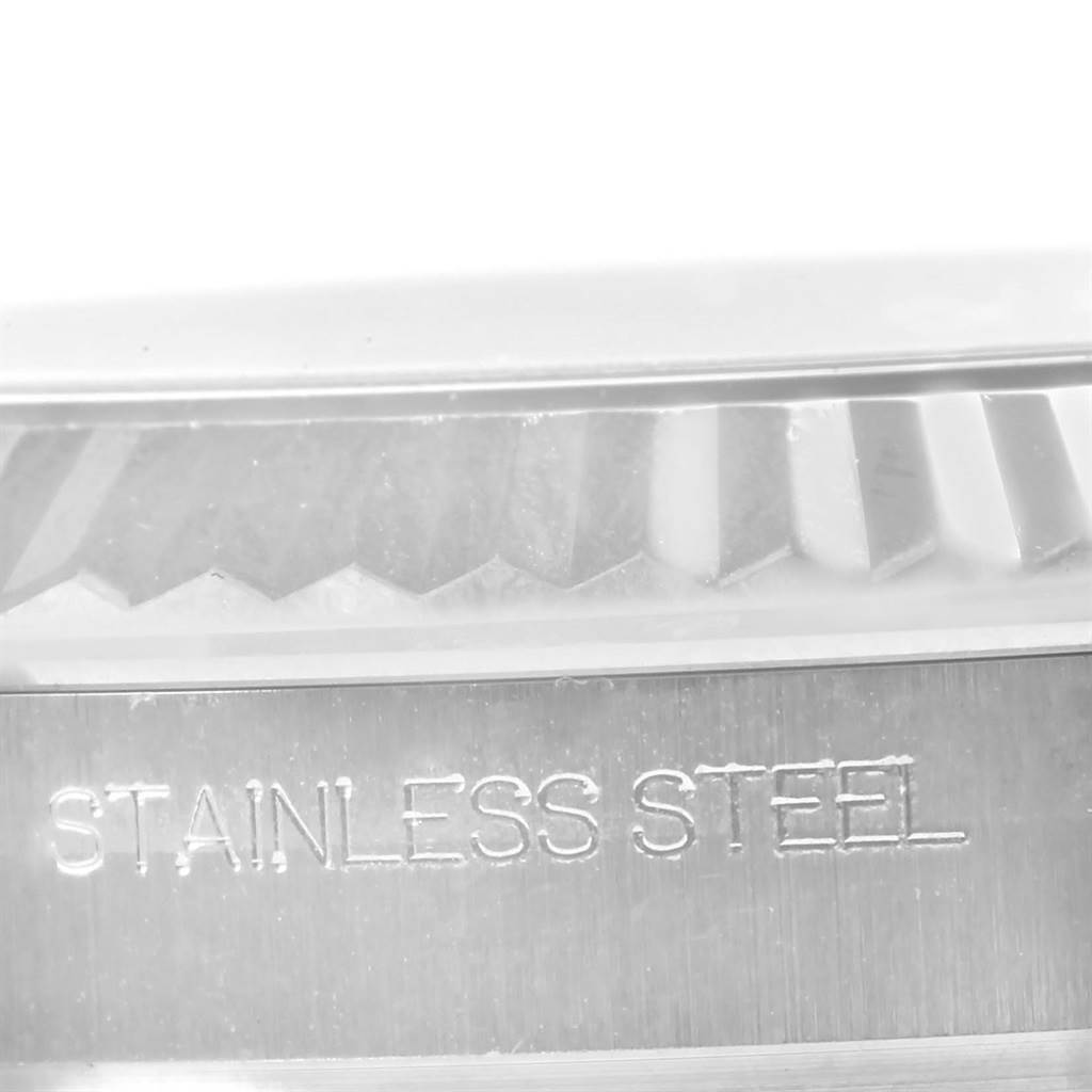 This close-up image shows the fluted bezel and part of the case back with "STAINLESS STEEL" engraving of the Rolex Datejust 41 116334 Men's Stainless Steel Silver Dial 116334 Men's Stainless Steel Silver Dial watch.