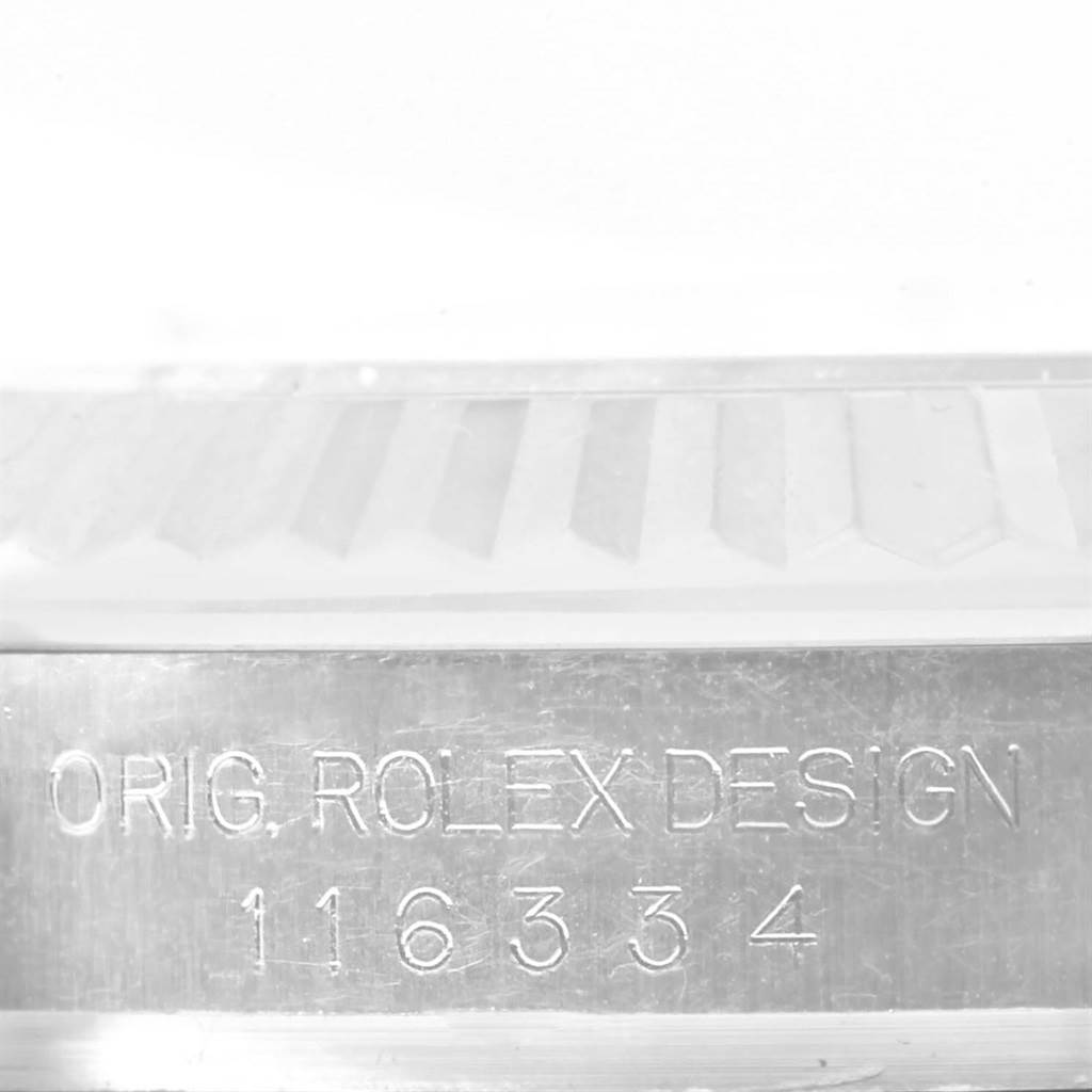 The image shows an extreme close-up of the side of a Rolex Datejust 41 116334 Men's Stainless Steel Silver Dial 116334 Men's Stainless Steel Silver Dial, focusing on the engraved serial number and "ORIG. ROLEX DESIGN."