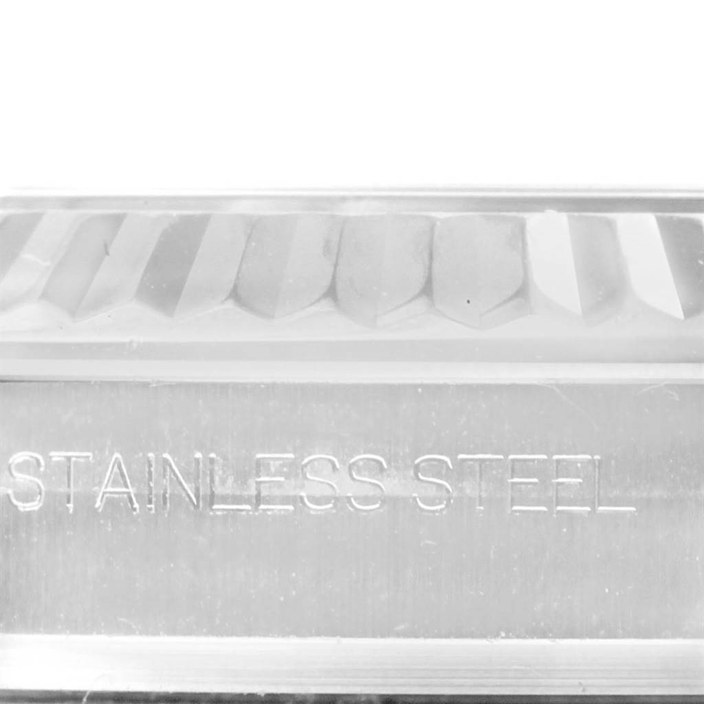 This close-up image of a Rolex Datejust 41 116334 Men's Stainless Steel Black Dial 116334 Men's Stainless Steel Black Dial watch shows part of the fluted bezel and the "STAINLESS STEEL" engraving.