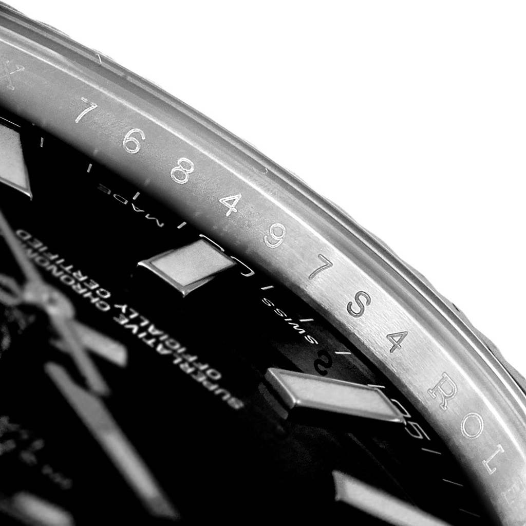 This close-up image shows the engraved inner bezel and part of the dial of a Rolex Datejust 41 116334 Men's Stainless Steel Black Dial 116334 Men's Stainless Steel Black Dial watch.