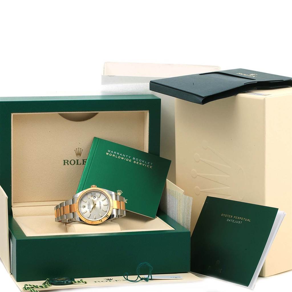 The Rolex Datejust 41 126333 Men's Steel and Gold (two tone) Silver Dial 126333 Men's Steel and Gold (two tone) Silver Dial watch is shown at an angle, displaying its box, booklets, and warranty card.