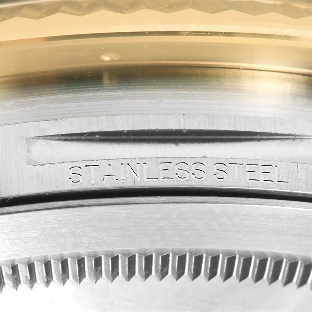 This is a macro shot of the stainless steel casing of the Rolex Datejust 41 126333 Men's Steel and Gold (two tone) Black Dial 126333 Men's Steel and Gold (two tone) Black Dial, focusing on the engraving and toothed bezel.
