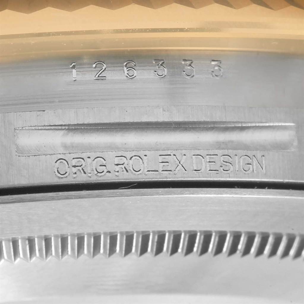 This close-up shows the model number and "ORIG. ROLEX DESIGN" engravings on the case of a Rolex Datejust 41 126333 Men's Steel and Gold (two tone) Black Dial 126333 Men's Steel and Gold (two tone) Black Dial watch.
