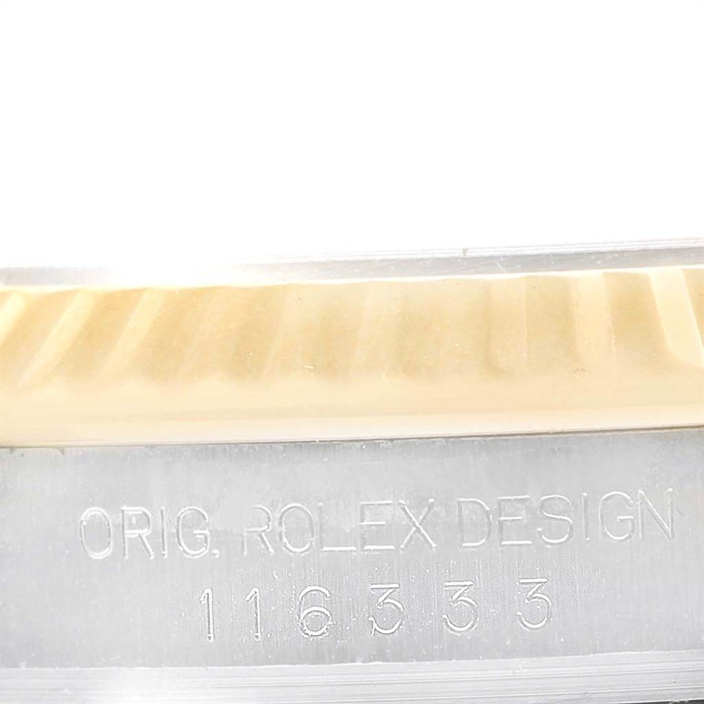 This close-up image of the Datejust 41 by Rolex focuses on the engraved serial number on the watch case.