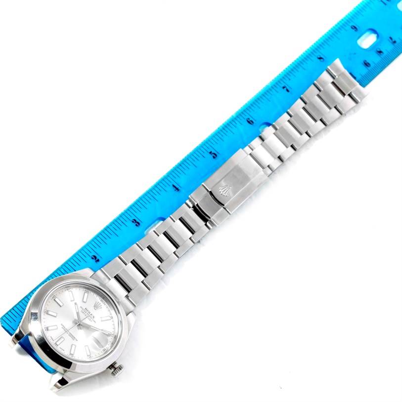 The image shows a top view of the Rolex Datejust 41 116300 Men's Stainless Steel Silver Dial 116300 Men's Stainless Steel Silver Dial watch, displaying its face, bracelet, and clasp alongside a ruler for scale.