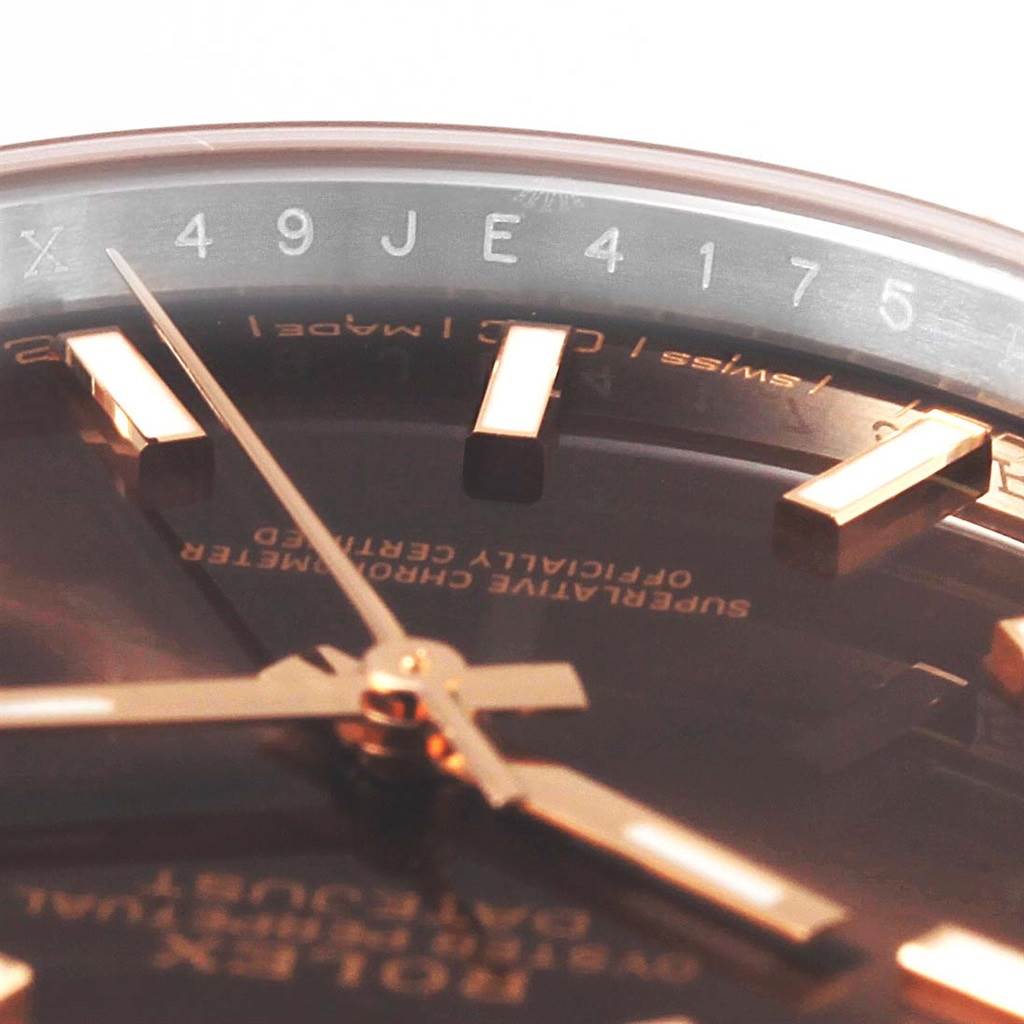 The image shows an angled close-up of the dial, hands, and part of the rehaut with engravings on the Rolex Datejust 41 126331 Men's Steel and Gold (two tone) Brown Dial 126331 Men's Steel and Gold (two tone) Brown Dial.