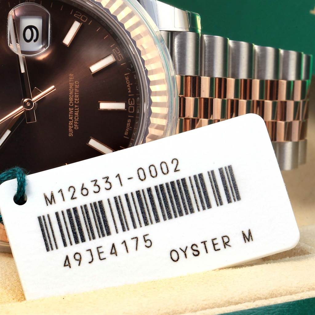 The image shows the dial, part of the bezel, and the bracelet of a Rolex Datejust 41 126331 Men's Steel and Gold (two tone) Brown Dial 126331 Men's Steel and Gold (two tone) Brown Dial model with an attached product tag.