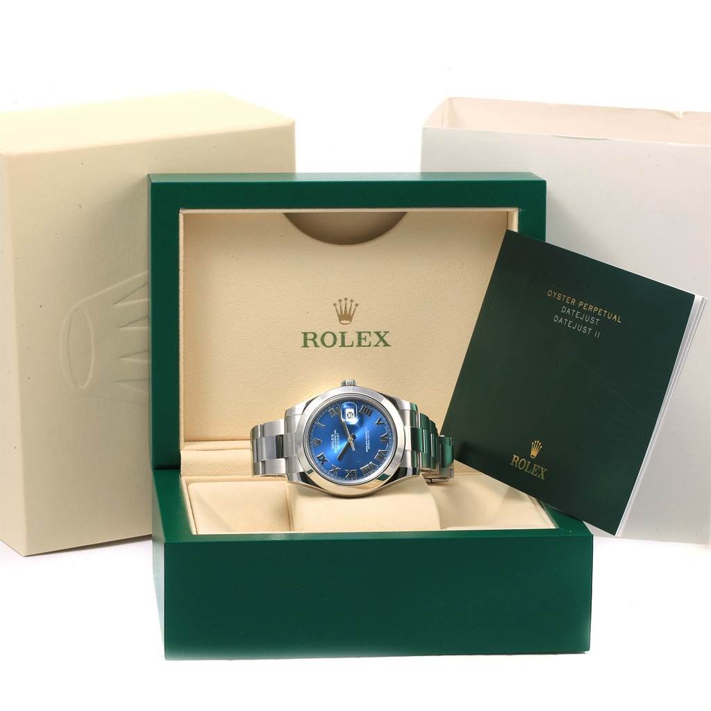 This image shows a Rolex Datejust 41 116300 Men's Stainless Steel Blue Dial 116300 Men's Stainless Steel Blue Dial watch with a blue dial, displayed inside its green and beige Rolex box with accompanying booklet.