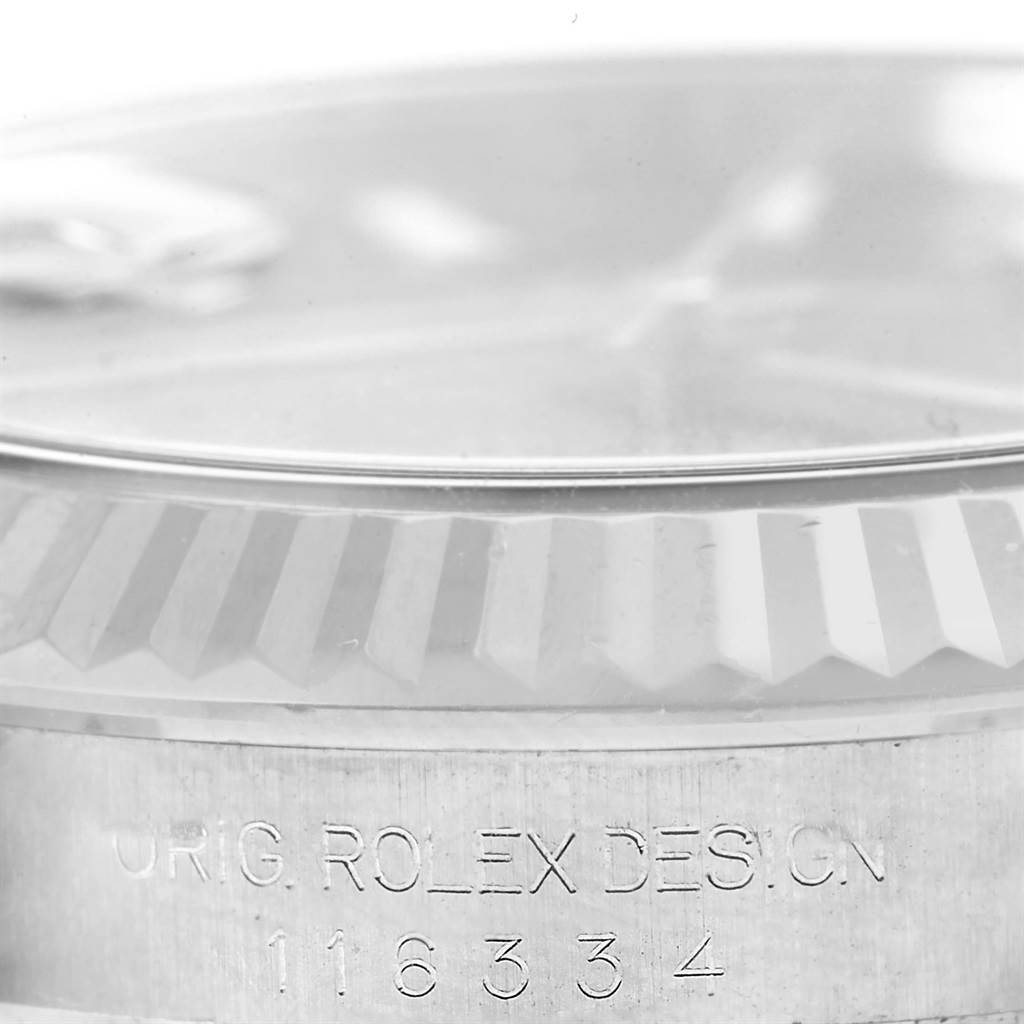 The image shows a close-up of the fluted bezel and case side of a Rolex Datejust 41 116334 Men
s Stainless Steel Black Dial 116334 Men
s Stainless Steel Black Dial model, capturing part of the dial and model number.