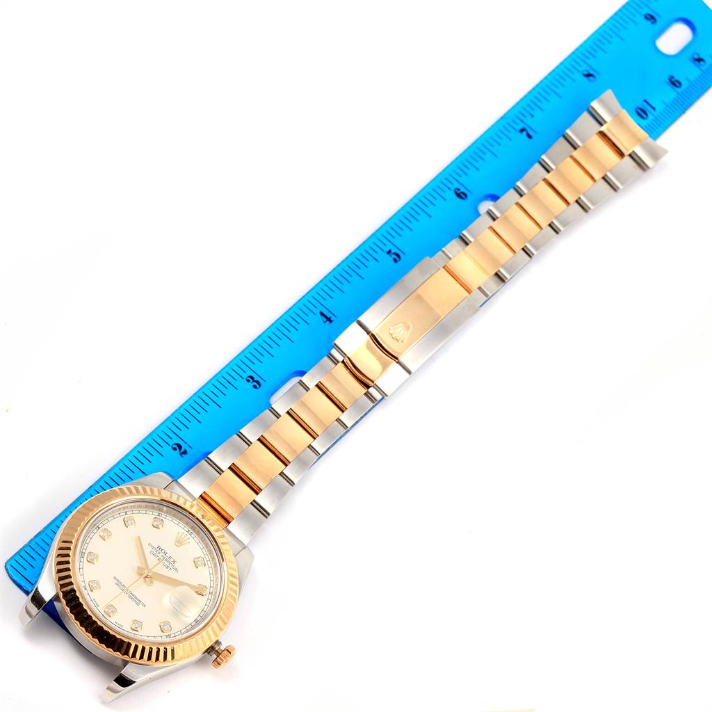 The image shows a Rolex Datejust 41 116333 Men's Steel and Gold (two tone) Silver Dial 116333 Men's Steel and Gold (two tone) Silver Dial watch laid horizontally with a blue ruler for scale.