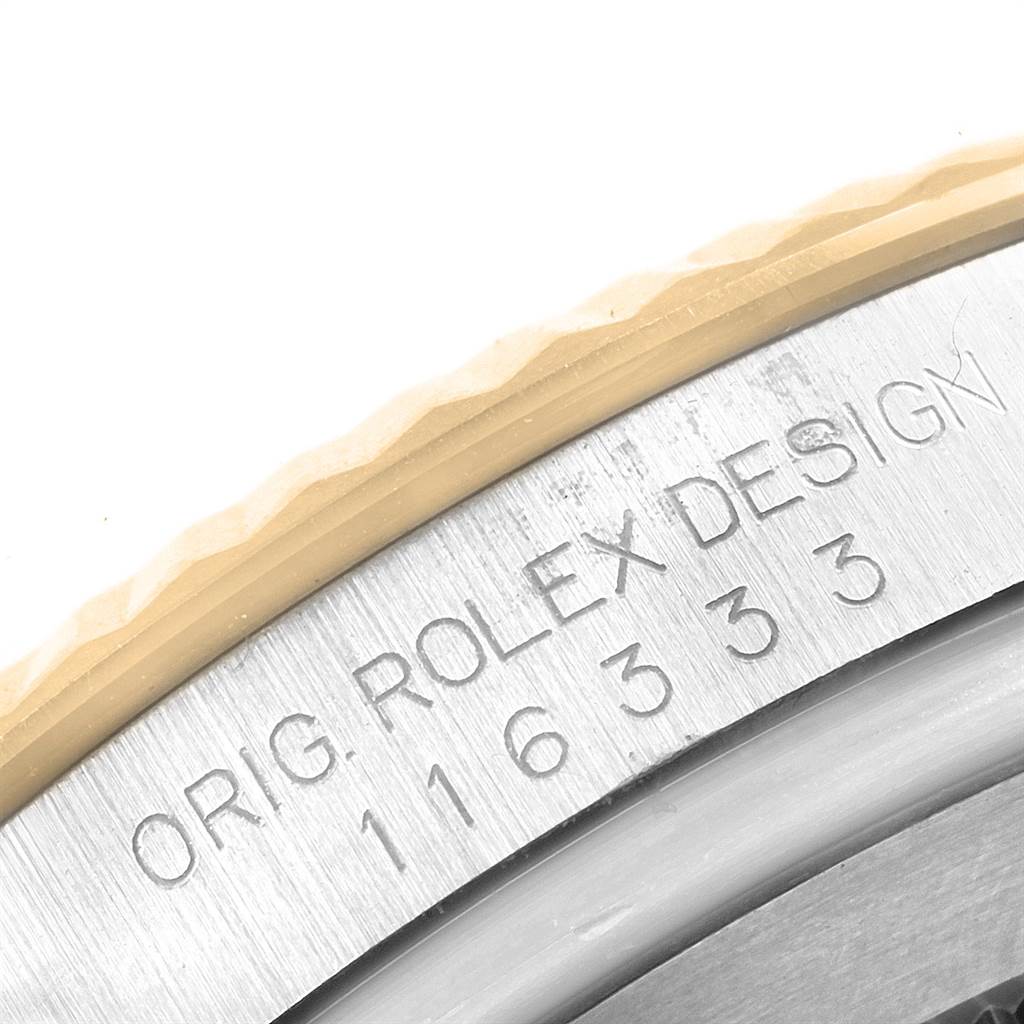 This is a close-up image showing the engraved details on the bezel of a Rolex Datejust 41 116333 Men's Steel and Gold (two tone) Silver Dial 116333 Men's Steel and Gold (two tone) Silver Dial model.