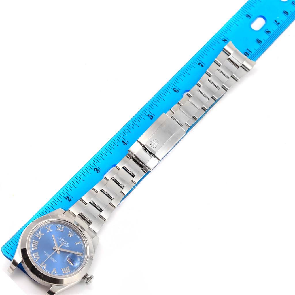 This Rolex Datejust 41 116300 Men's Stainless Steel Blue Dial 116300 Men's Stainless Steel Blue Dial watch is shown from a top-down angle, featuring the face, bracelet, and clasp with a ruler for scale.