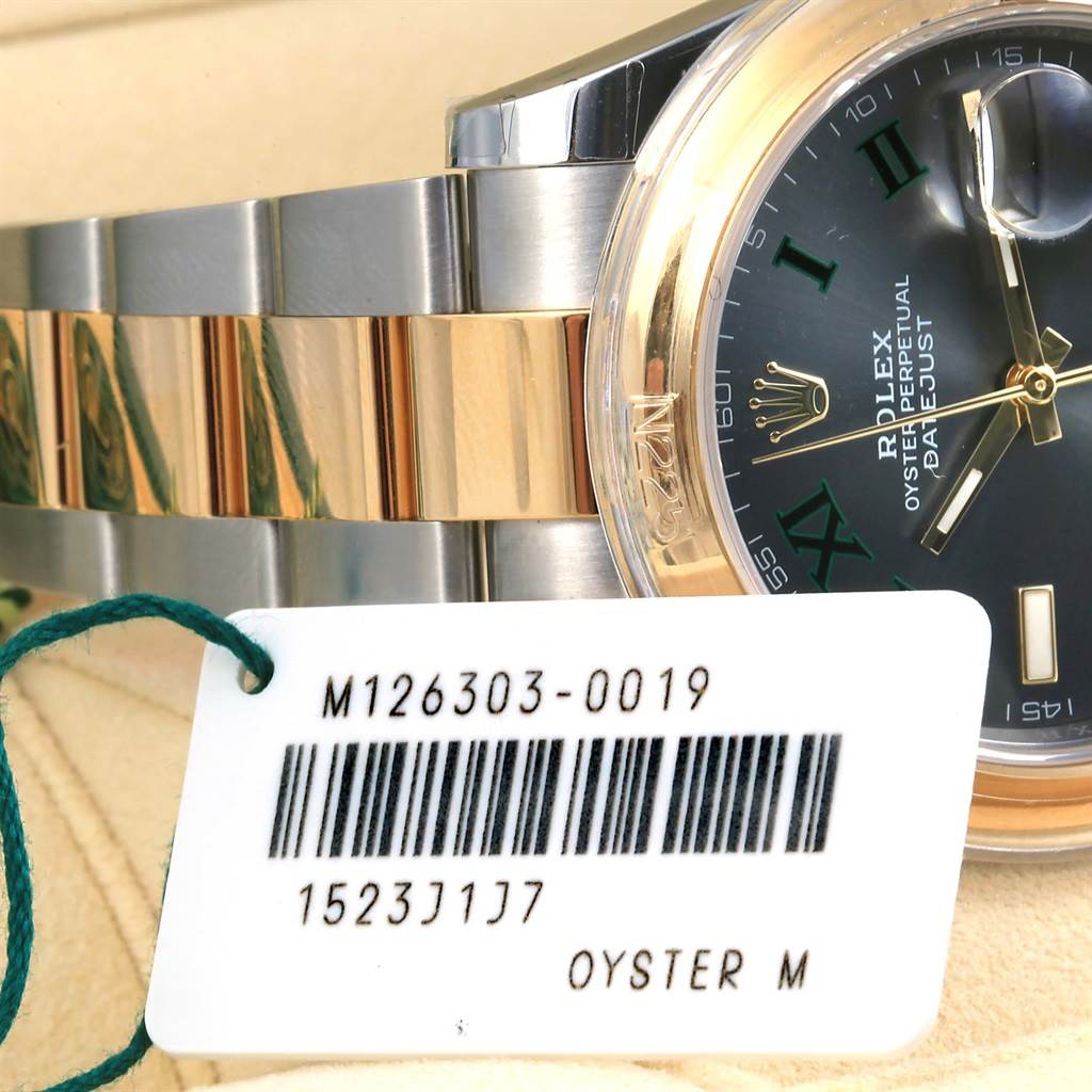 The image shows a partial close-up of Rolex Datejust 41 126303 Men's Steel and Gold (two tone) Grey Dial 126303 Men's Steel and Gold (two tone) Grey Dial watch, focusing on the bracelet, bezel, and a portion of the dial along with a tag.