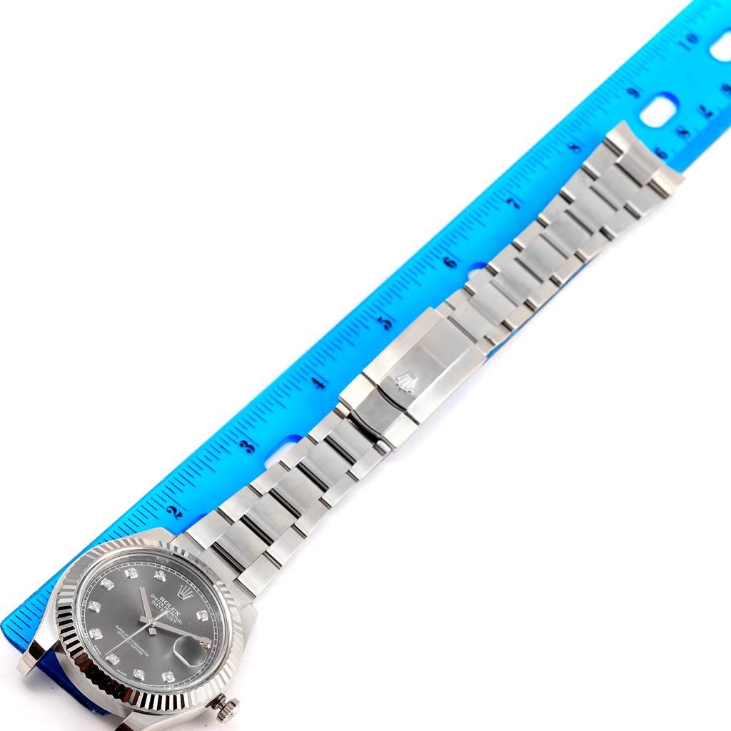 The image shows a Rolex Datejust 41 116334 Men's Stainless Steel Grey Dial 116334 Men's Stainless Steel Grey Dial watch laid flat next to a ruler, displaying its bracelet, clasp, and part of the dial.