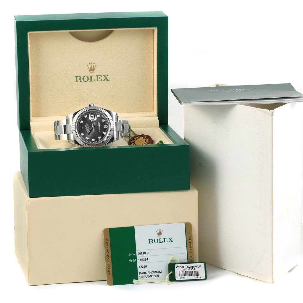 The Rolex Datejust 41 116334 Men's Stainless Steel Grey Dial 116334 Men's Stainless Steel Grey Dial watch is displayed in its box with tags, warranty card, and manual next to it.