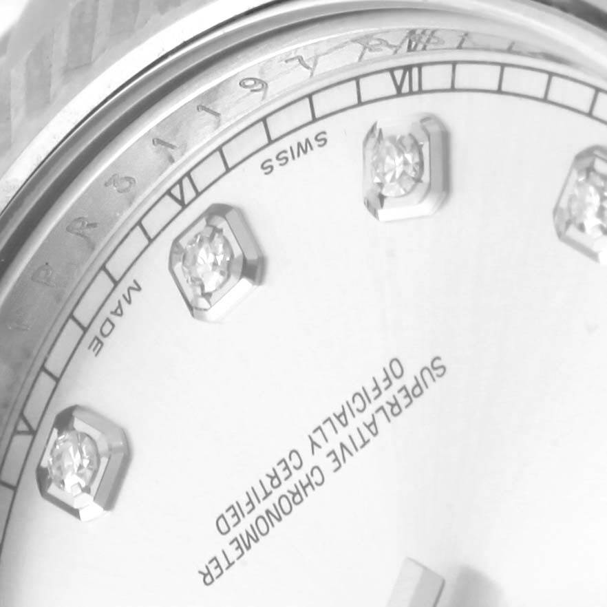 The image focuses on the upper part of the Rolex Datejust 41 116334 Men's Stainless Steel Silver Dial 116334 Men's Stainless Steel Silver Dial's dial, displaying diamond hour markers and part of the bezel.